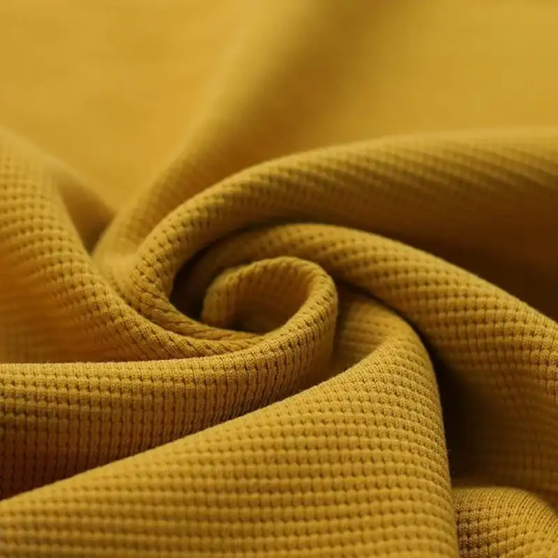 Waffelstrick-Jersey-Stoff Ocker ideal zum Nähen für Baby- und Kinderkleidung.